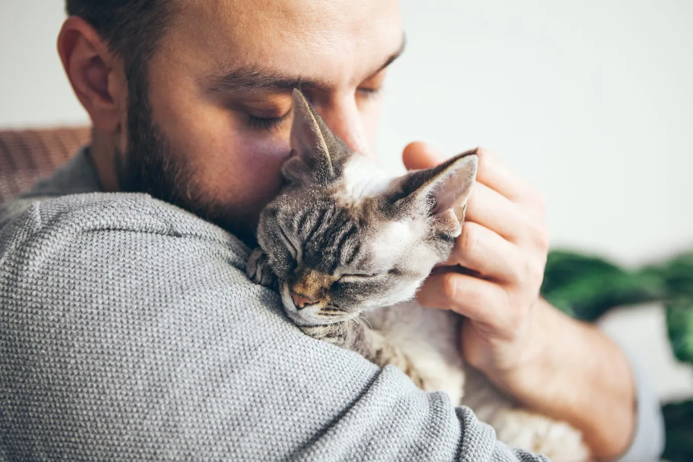 Man hugging cat