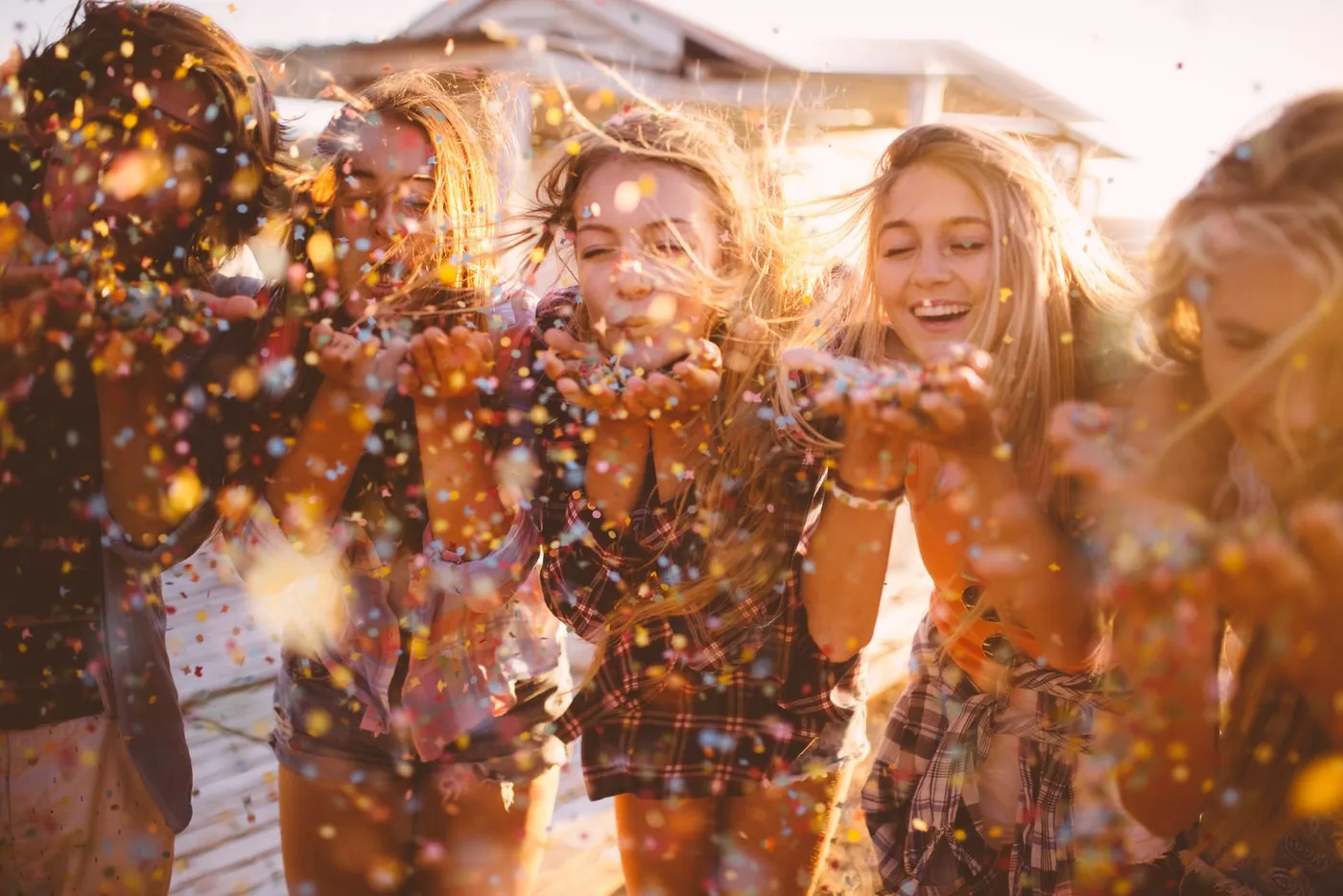Friends blowing confetti